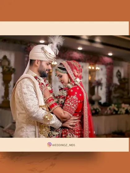 A romantic portrait of the couple during their varmala ceremony, framed with a modern graphic element.