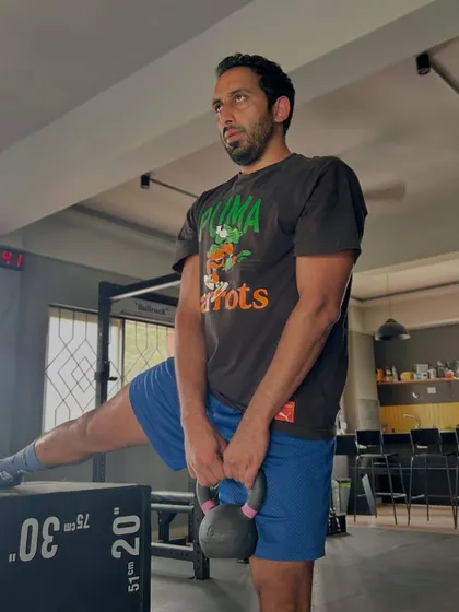 Here I'm performing a loaded Cossack squat with a kettlebell. This exercise is excellent for building single-leg strength and improving hip and adductor mobility, which directly translates to a healthier lower back.