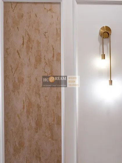 A stunning wall light detail from the Kolkata project. The modern gold fixture adds a touch of artistry and warm, ambient light to the space.