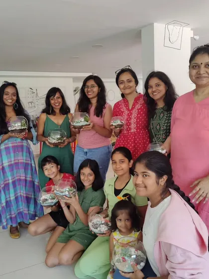 A happy group of mothers and children posing with their finished terrariums. It's always a pleasure to see so many happy campers at the end of a workshop.