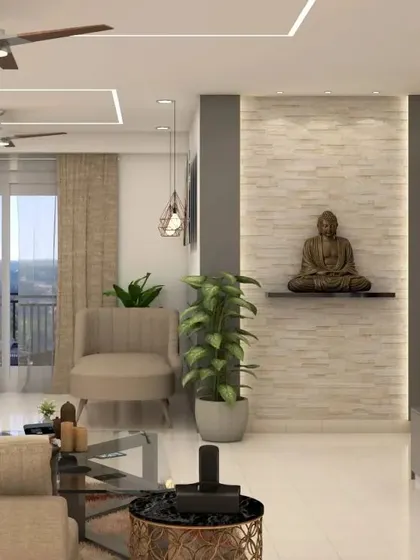 This design integrates a spiritual corner into the living room. A Buddha statue is placed on a floating shelf against a textured stone-cladding wall with accent lighting, creating a peaceful zone within a larger space.