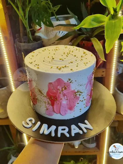 I love doing textured cakes. This design uses a palette knife to create abstract floral patterns in shades of pink, finished with a sprinkle of gold.