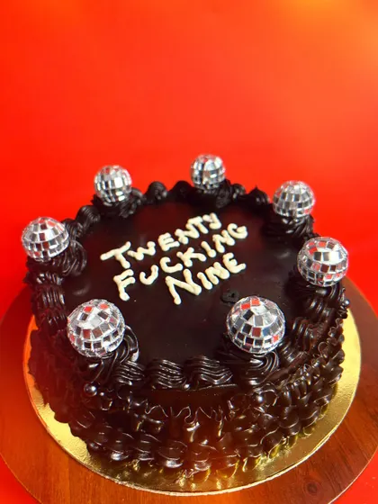"Twenty Fucking Nine". A dark chocolate cake with mini disco balls that tells it like it is. Let me help you make any birthday special with a cake that has zero filter.