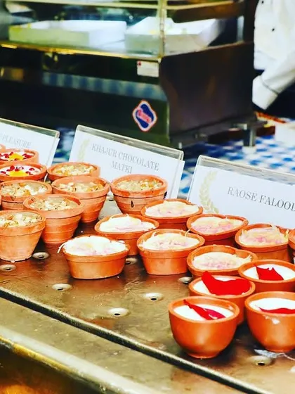 A variety of Indian desserts served in traditional clay pots (kulhads). This includes favorites like Rasmalai Falooda and Litchi Malai, presented in an earthy and authentic style.