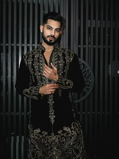 This black velvet kurta set is made for sophisticated celebrations. The exquisite gold handwork glistens with every movement, and the luxurious fabric drapes beautifully, ensuring you are the center of attention at any festive event.