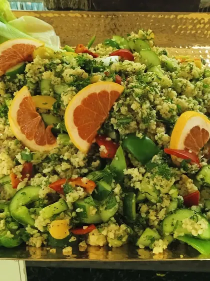 A citrus-infused couscous salad with bell peppers and cucumber, a light and refreshing option for any event.