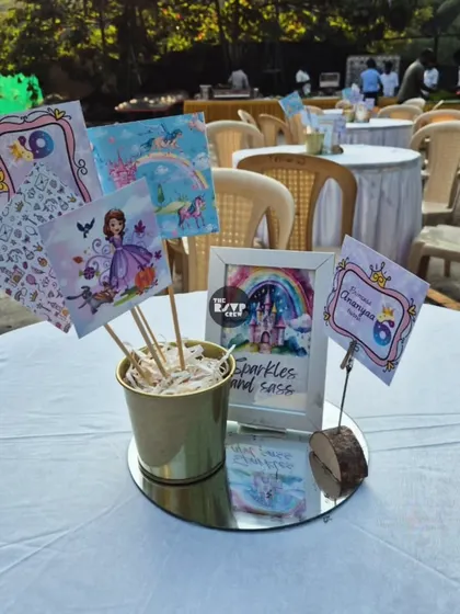 A charming princess-themed centerpiece for the guest tables, featuring cutouts and signs with sparkles and sass.