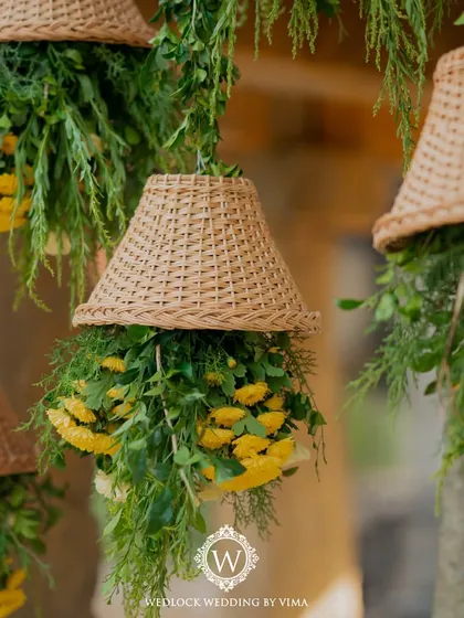 For this Haldi, we focused on a vibrant yellow theme with rustic touches. We used hanging cane baskets filled with yellow flowers, lush greens, and traditional brass urlis to create a warm and sunny celebration.