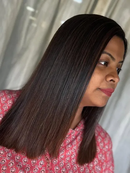A side view of the dazzling results. The hair is sleek, shiny, and looks incredibly healthy after our smoothing and color service.