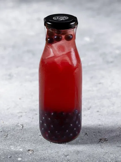 A bottled blueberry beverage for Chili's India. The simple, clean shot on a neutral background is ideal for menu and catalog purposes.