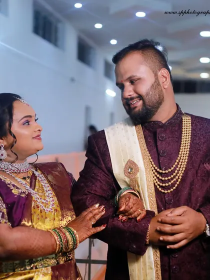 A lovely portrait of the couple at their reception. This shot highlights their elegant attire and the happy, relaxed atmosphere of the celebration.