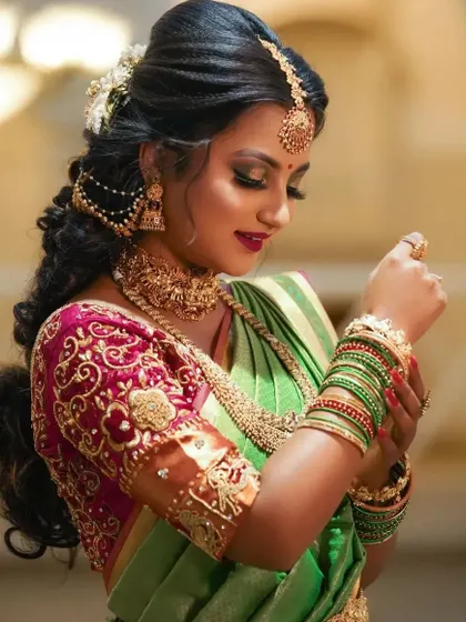 A side profile showcasing the intricate details of the hairstyle, adorned with our traditional hair accessories, and the matching jhumkas.