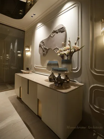 This bespoke crockery cabinet, finished in a smooth PU paint, features seamless brass handles for a clean, modern look. It serves as the perfect backdrop for a commissioned multimedia artwork, adding a personal touch to the dining space.