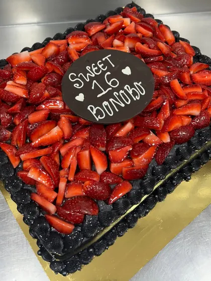 A huge "Sweet 16" celebration calls for a showstopper. This is a large Belgian chocolate cake piled high with fresh strawberries.