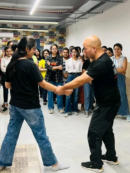 An employee practices the wrist grab escape. Notice how the other participants watch intently. This shared learning experience is excellent for team bonding.