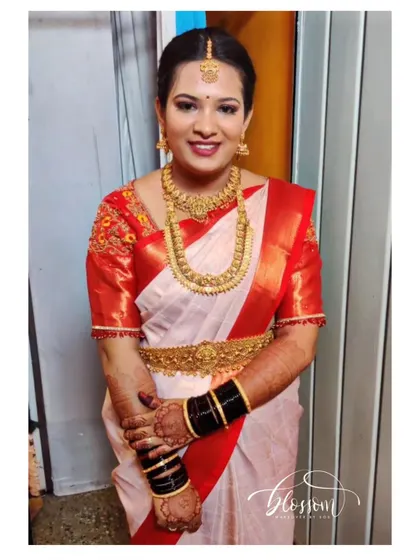 I loved creating this look for my cousin. The classic combination of an off white saree with a vibrant red border is timeless. The drape is traditional and secure, perfect for a family function.