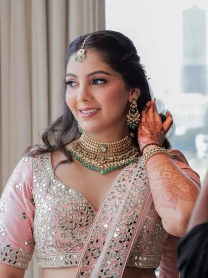 A lovely portrait of the bride, looking happy and confident. The makeup enhances her natural beauty, giving her a polished and elegant engagement look.