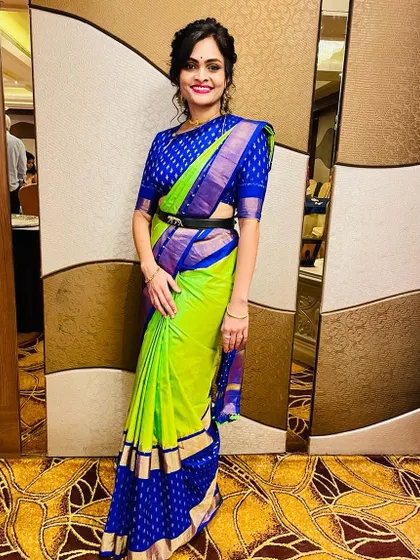 This client looks so chic. I love how she styled her custom blue brocade blouse and neon green saree with a modern belt.