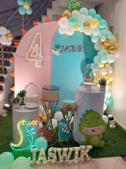 A roarsome dinosaur theme for Jaswik's 4th birthday. We used pastel balloons, cute dinosaur cutouts, and neon dino lights to create a fun and friendly prehistoric party.