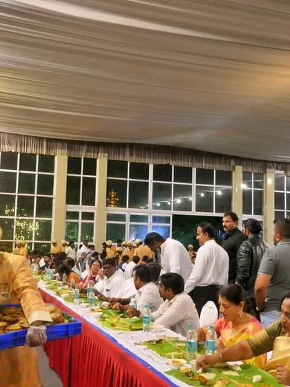 A server carries a tray of freshly prepared items, ready to be served to guests. I ensure that the food is always hot and the service is prompt throughout the meal.