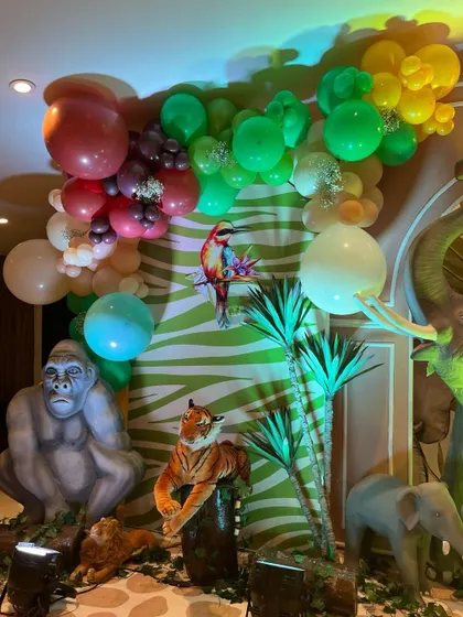 A detailed shot of the jungle decor, showing a gorilla and tiger sitting amongst tropical plants and colorful balloons.