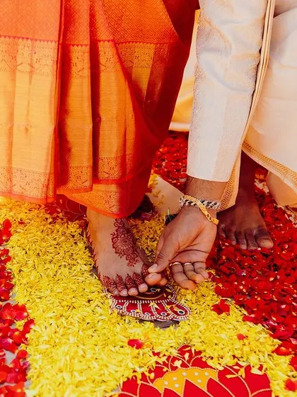 The Saptapadi, or seven steps, is a significant ritual where the couple walks together, symbolizing their journey ahead. The floral path adds a beautiful touch to this meaningful tradition.