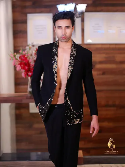 For the bold and daring. A model walks the ramp in our black sequined blazer, worn open for a high-fashion, edgy look.