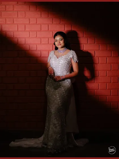 A beautiful portrait of the bride, framed by shadows, showcasing her poise and the intricate details of her gown.