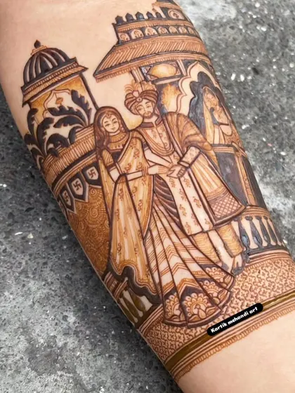 A close-up of a beautifully rendered couple portrait. The detail in their clothing and expressions showcases our expertise in creating lifelike figures for your bridal mehandi.