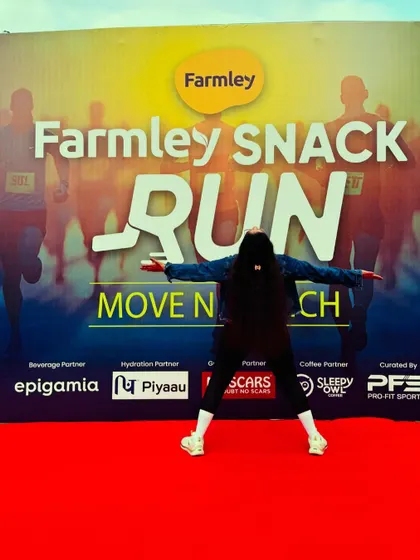 The joy of running. A participant poses against the backdrop of the Farmley Snack Run.