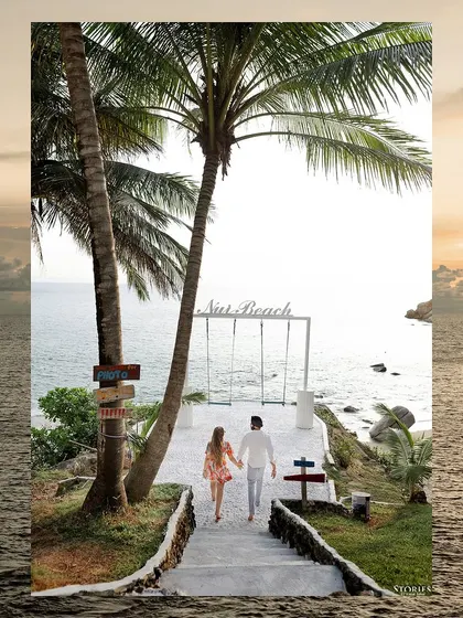 An artistic shot of the couple walking towards Nui Beach, framed by the ocean, creating a sense of a journey beginning.