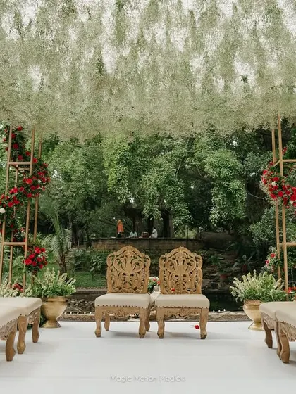 A breathtaking mandap setup at our Pond Pavilion, featuring a canopy of baby's breath and elegant seating. This showcases how our spaces can be customized for your dream wedding ceremony.