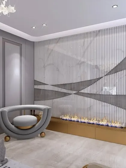 This view showcases a unique fireplace feature wall with a dynamic, wavy design in marble and fluted panels. A sculptural armchair creates a cozy and artistic reading nook.