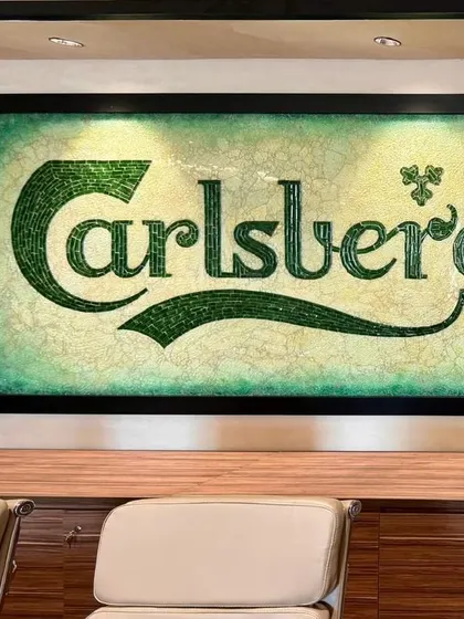 The finished recycled glass mosaic of the Carlsberg logo, a unique piece of art that serves as a focal point in the boardroom.
