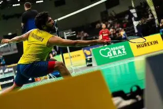 An action shot of Raghu Mariswamy during the Austria Series 2024, showcasing the dynamic lunging technique required for international-level singles play.