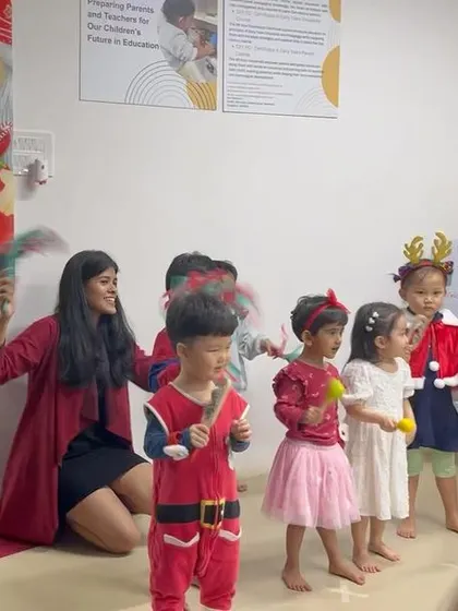 A line of our youngest performers, dressed in red and holding instruments, with their teachers by their side. Even our toddlers get to be part of the show.