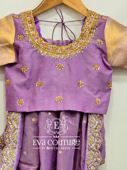 A close-up of the lilac blouse from the previous set. You can see the fine maggam and stone work around the neckline and the scattered butti embroidery on the body.