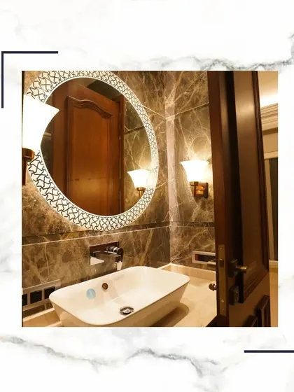 Unravel the allure of timeless elegance with this beautifully designed vanity area, featuring a decorative mirror, wall sconces, and a vessel sink.