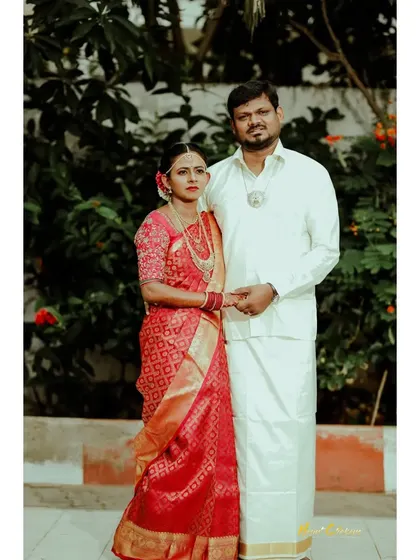 A classic portrait of a couple in traditional South Indian wedding attire.