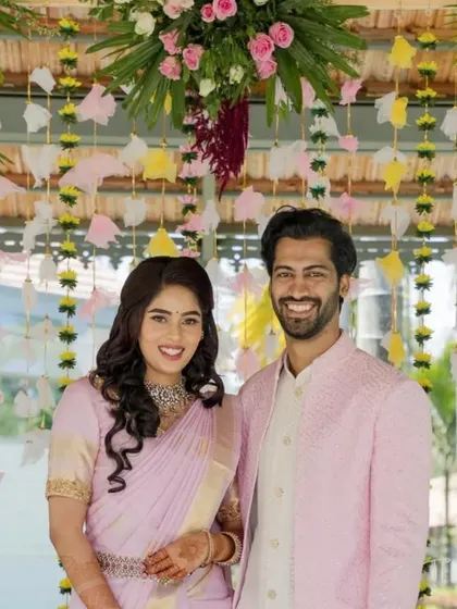 A portrait of happiness. The couple smiles against the backdrop of the colorful and celebratory engagement decor we curated for their special day.