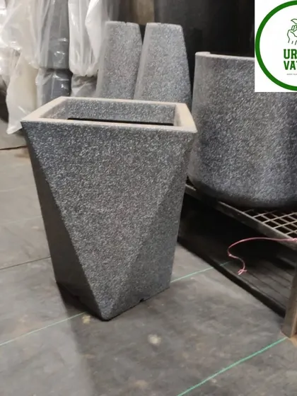 A geometric-patterned fiber pot, adding a modern touch.
