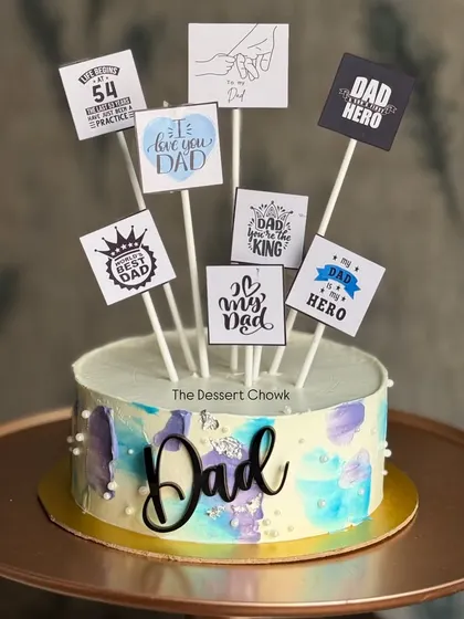 A thoughtful cake for Dad, decorated with multiple toppers expressing love and appreciation.