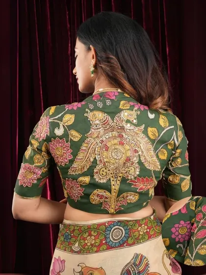 The back of this Pen Kalamkari blouse is a work of art in itself. The symmetrical peacock design is a classic motif in Indian art, painstakingly hand-painted by master artisans.