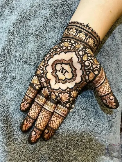 A personalized design for a guest, featuring their initials in a beautiful central motif. The surrounding floral pattern is intricate yet doesn't cover the entire hand, making it an elegant choice.