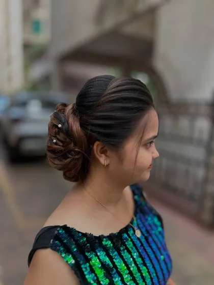 A side view of the twisted bun hairstyle, showing the clean lines and elegant shape.