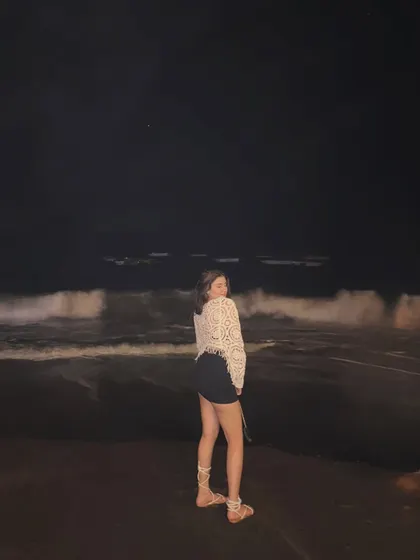 A happy, candid moment on the beach at night, with the waves crashing behind me.