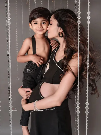 So much love in one photo! A mom holding her son close while cradling her baby bump is a powerful image of a growing family's love.
