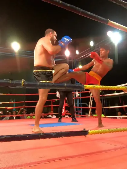A fierce exchange of kicks in the championship final. Both fighters leaving it all in the ring.