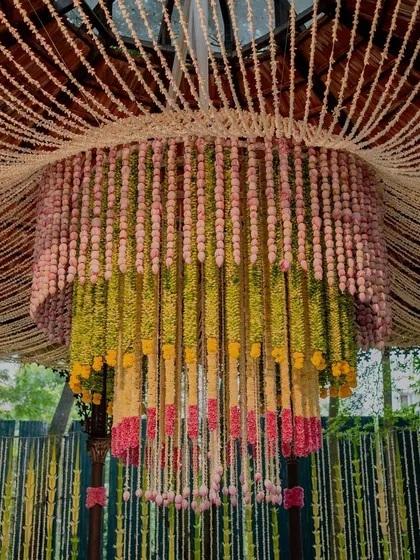 A magnificent floral chandelier made from thousands of flowers in different colors. This statement piece becomes a central focal point of the mandap, creating a breathtaking effect.