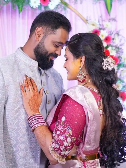 An intimate photo of the couple. The bride's custom blouse features delicate floral embroidery on the sleeves.